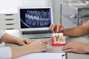 a dentist and patient discussing dental implants