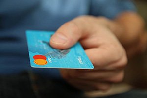 Man holding debit card for payment