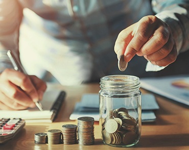 Person piling up coins