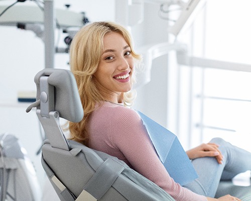 Patient smiling while sitting in treatment chair