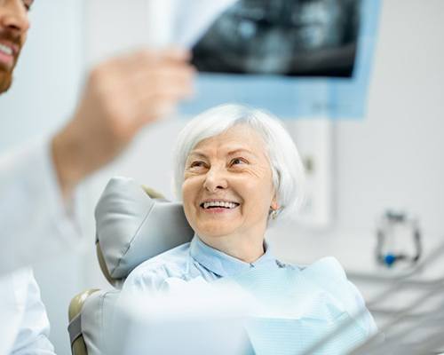 Dentist showing patient her dental X-ray