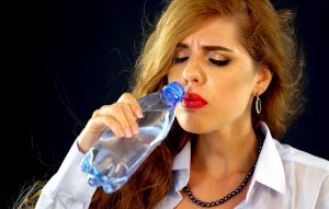 woman frowning from drinking cold water