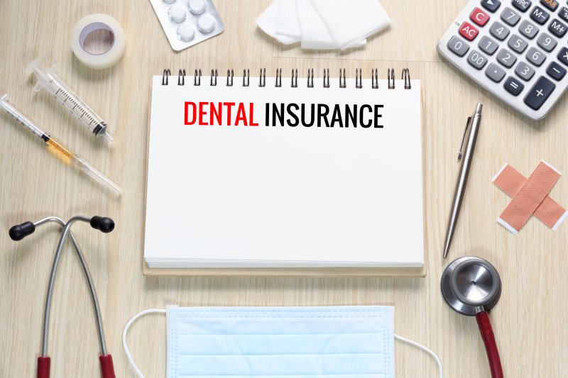 Notepad reading “Dental Insurance” surrounded by medical equipment